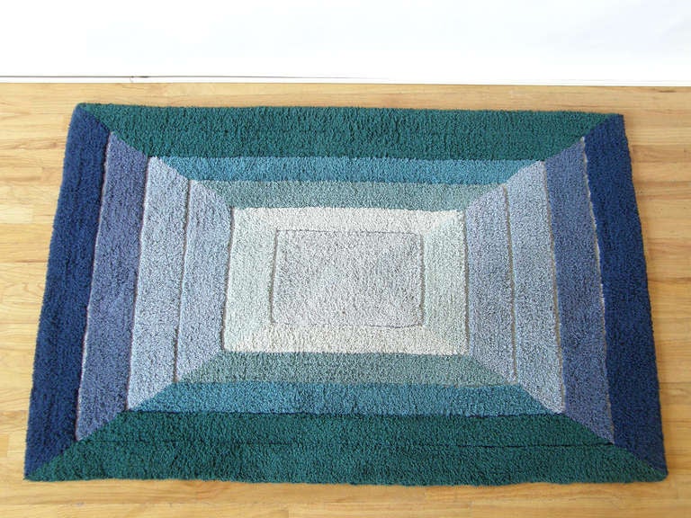 This small Op Art rug has a bold design of graduated rectangles in shades of blue and green. Makes a nice accent rug or focal point for a small piece of furniture or decorative art. See our other listing for a larger version of this rug.

Please