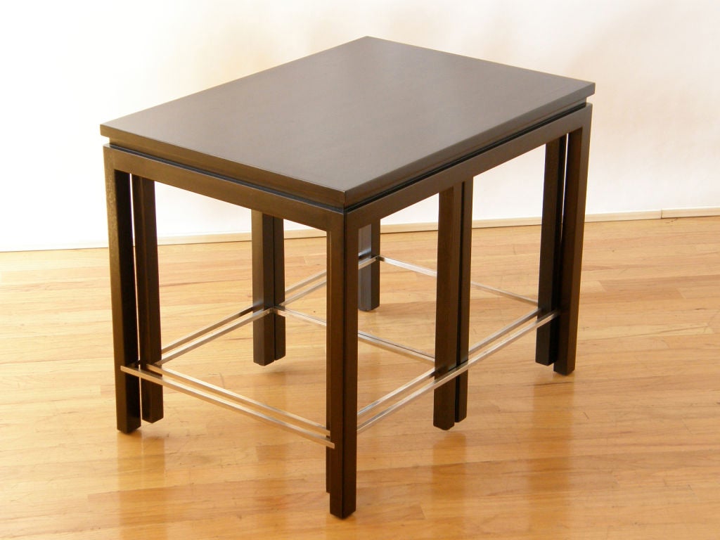 Set of 3 mahogany nesting tables designed by Edward Wormley for Dunbar. The stainless steel stretchers were custom ordered for the tables by Chicago designer Jane Graham.

Please contact us if you have any questions.