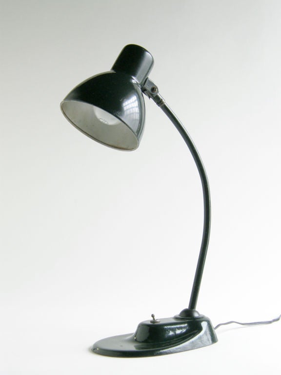 Artist, sculptor, designer and teacher Marianne Brandt's desk lamp by Kandem is a classic, Bauhaus inspired design.  The adjustable arm and shade make it an excellent task / work lamp. Original forest green enamel.

Please contact us if you have any