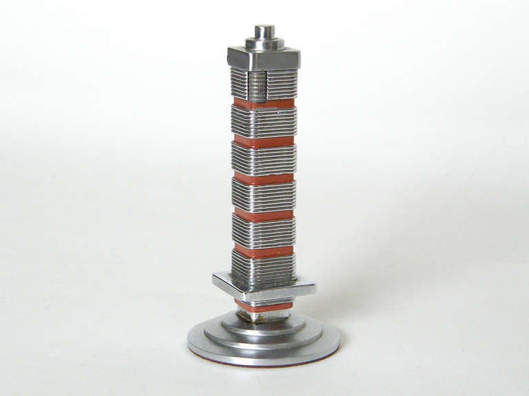 Lighter in the shape of the Research Tower that Frank Lloyd Wright designed for the Johnson Wax Company. It has a strong architectural presence. These models were given as gifts by the company, c. late 1940s.

Please use Contact Dealer button if