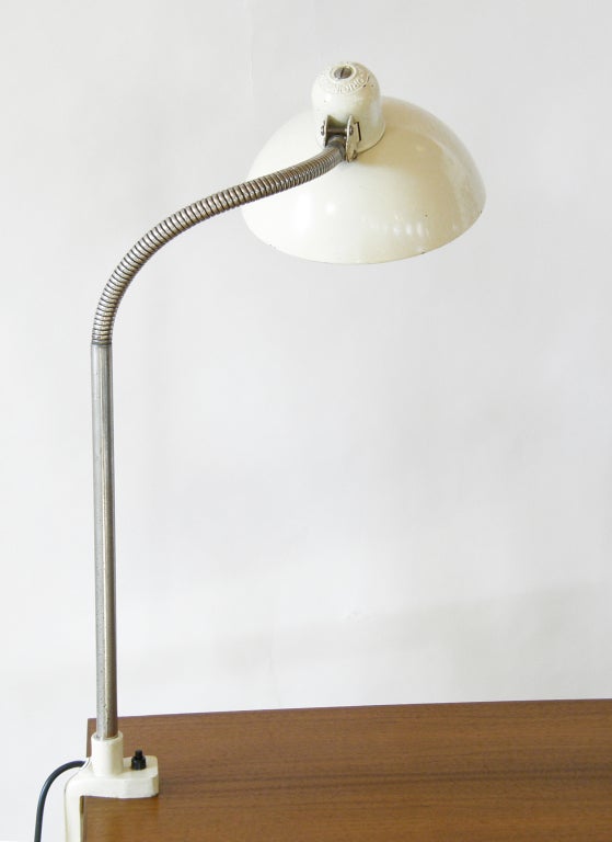 Clamp-on table lamp designed by noted Bauhaus designer and teacher Christian Dell for Kaiser, Germany. The gooseneck section of the arm and the pivot joint at the shade allow for adjusting the direction of the light, which makes it an excellent work