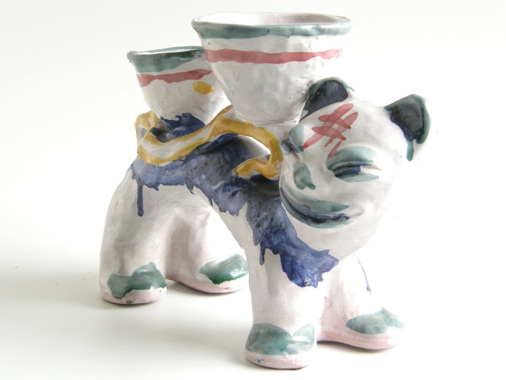 Feline figural vase by Walter Bosse. 
His 'grotesque' pottery figurals noted a 1930's movement of modernist artists celebrating native artisan style. Asian, European and native American influences are visible in this piece.