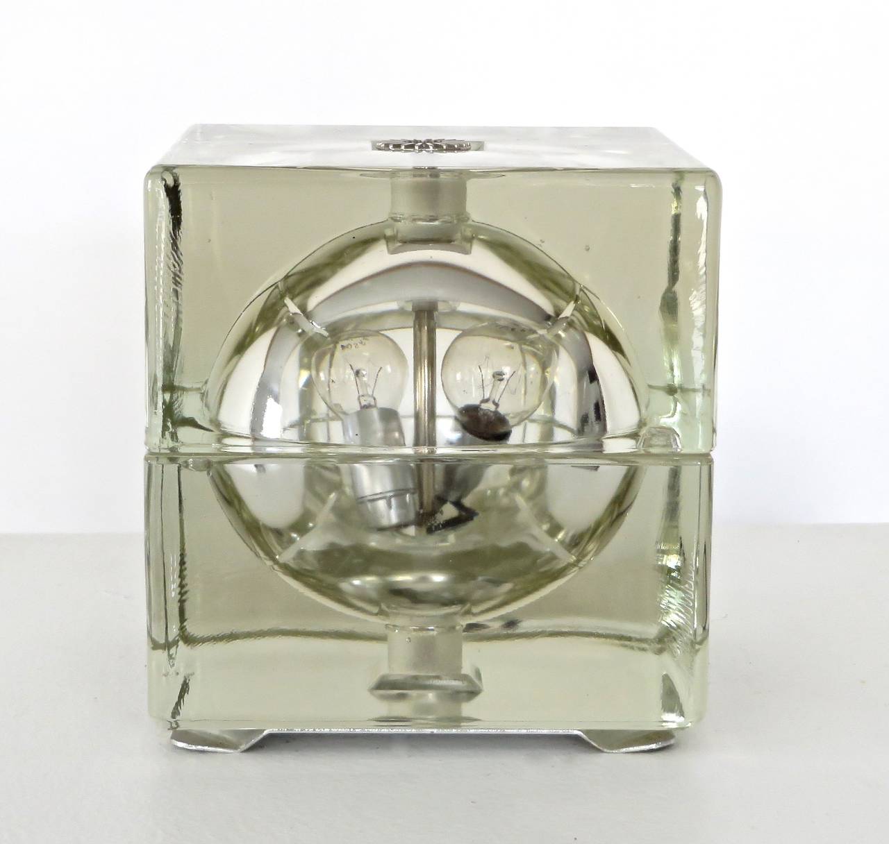Cast glass Cubosfera lamp by Alessandro Mendini, two part cube with internal sphere by Fidenza Vetraria, Italy, 1968. Two light sources in the interior. Switch on the cord. 
Active since the 1960s has been not only a designer but an important