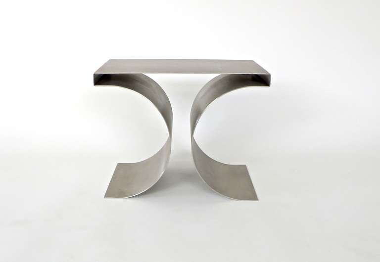 Michel Boyer “X” Stool or Coffee Table. Stainless steel folded x form stool by French designer Michel Boyer. This was designed by Boyer to be used as stools with a cushion or use as is without as a side table. Documentation provided upon request.