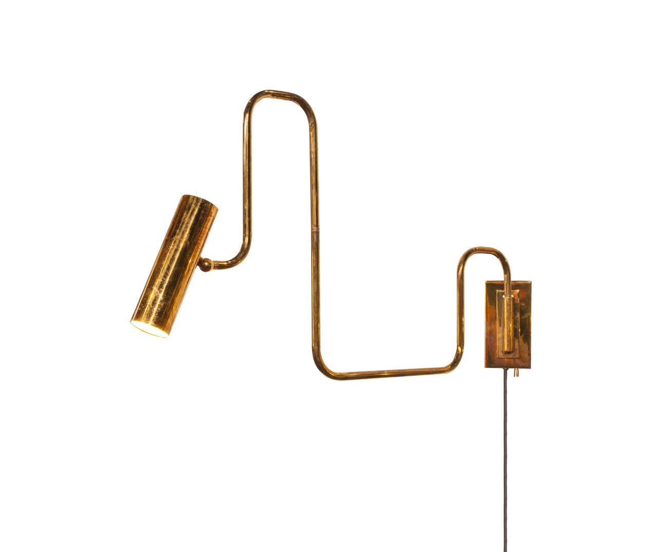 Brass handmade pivot light designed by Christopher Gentner. A perfect swiveling wall light for next to the bed, desk or any situation. The finish is called tarnished brass. 
The arm swivels in many directions as well as the tubular head of the