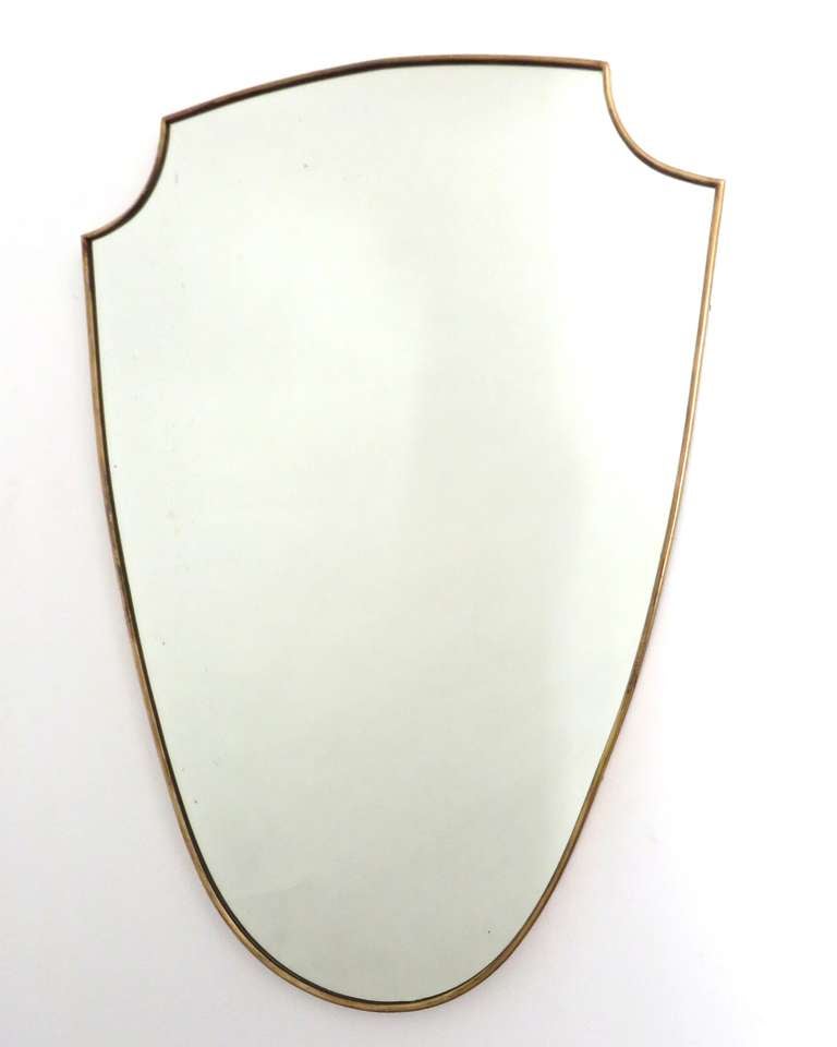 Brass framed Italian mirror, Italy, c. 1950. Brass shows beautiful, age appropriate patination. Original mirror. In the manner of Gio Ponti.
23