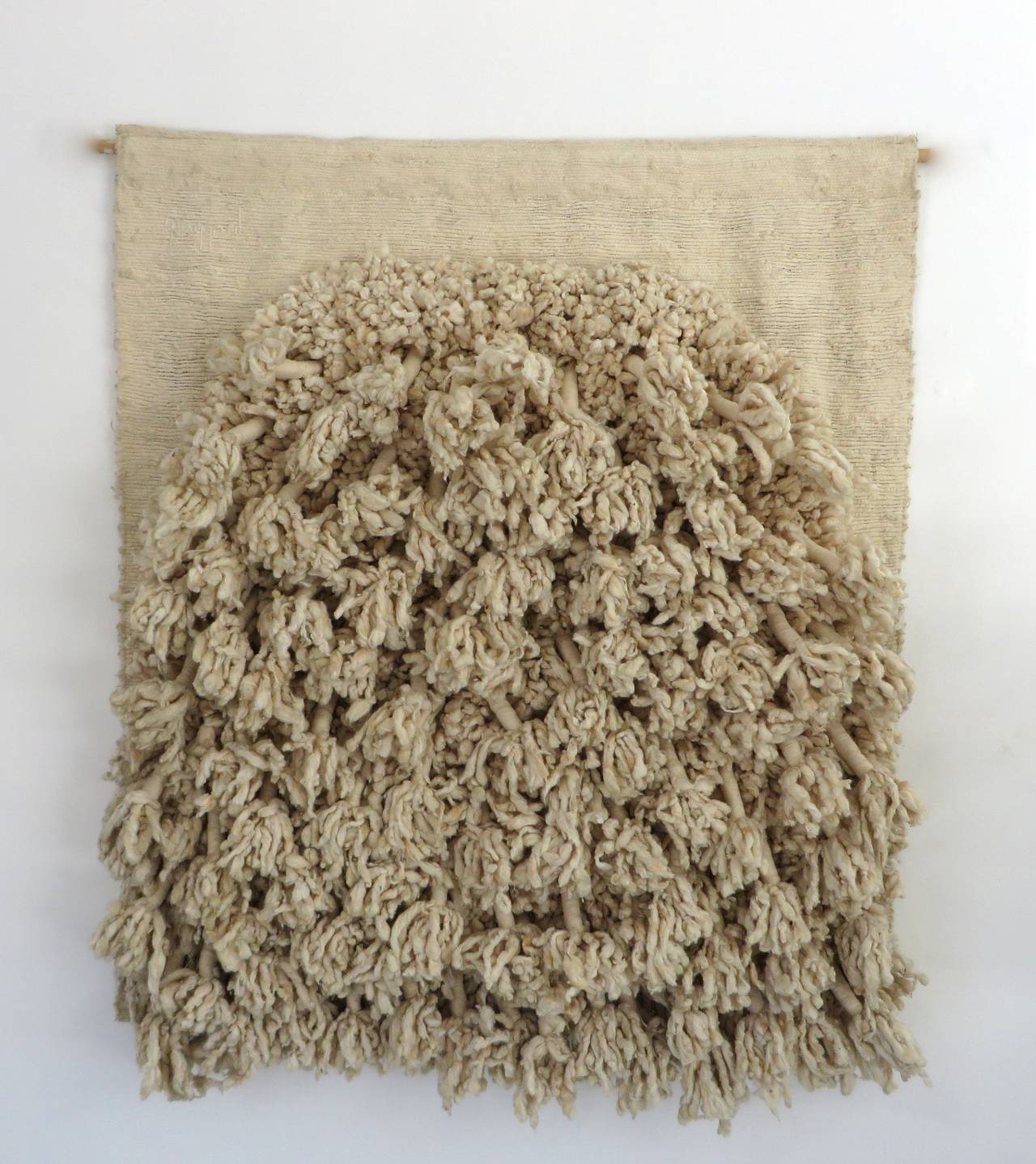 French wool fiber art sculptural wall hanging in the style of Sheila Hicks. 
Cream woven, tied, and knotted raw wool and fine linen and silk thread.
c 1970. Signed Taggart.