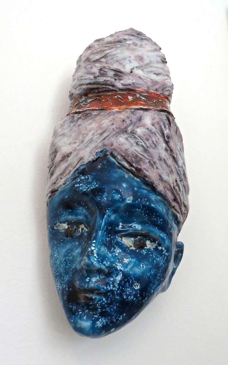 Polychrome glazed fanciful Italian ceramic head signed Pucci. To be hung on the wall.