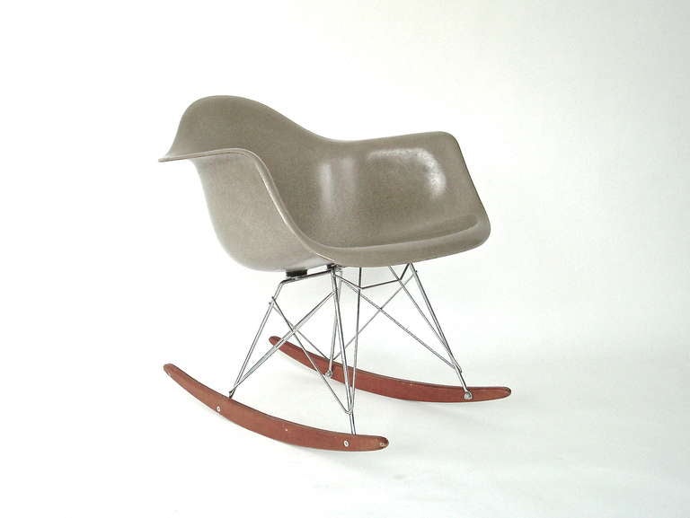 An Early Eames Rocker by Charles & Ray Eames for Herman Miller. Wonderfully putty colored fiberglass. Originally produced in only 3 neutral colors in 1948, greige, elephant hide gray and parchment. This is a wonderful greige example. 
Classic Eames