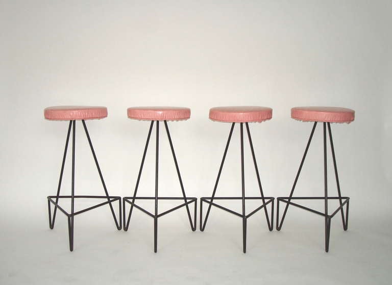 Iconic 50's design for American bar stools, sturdy wrought iron base support a round original pink vinyl seat, in excellent condition to use as is or ready for reupholstery. Excellent condition as is. The seat is 13.25 