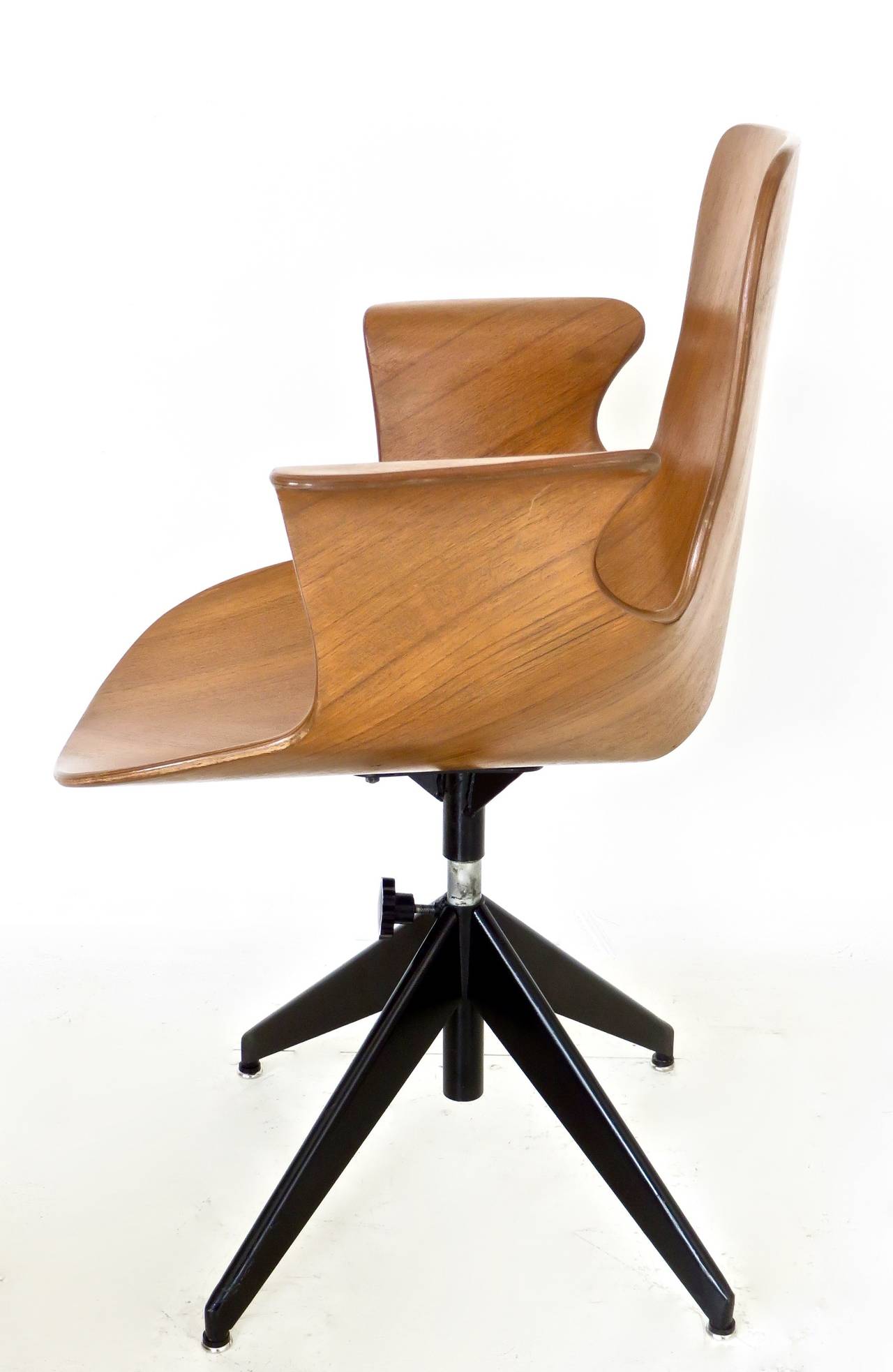 The Medea desk chair by Vittorio Nobili for Tagliabue. 
Elegant molded walnut wood seat on a black enamel swivel base.
4 brass caps on seat. Matte finish on the wood. No chips or restorations. 
The seat can be raised or lowered via the black knob