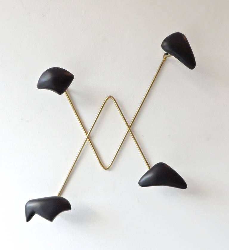 Wall-mounted coat rack by Georges Jouve, produced by Asselbur, France, circa 1950. Black glazed earthenware.