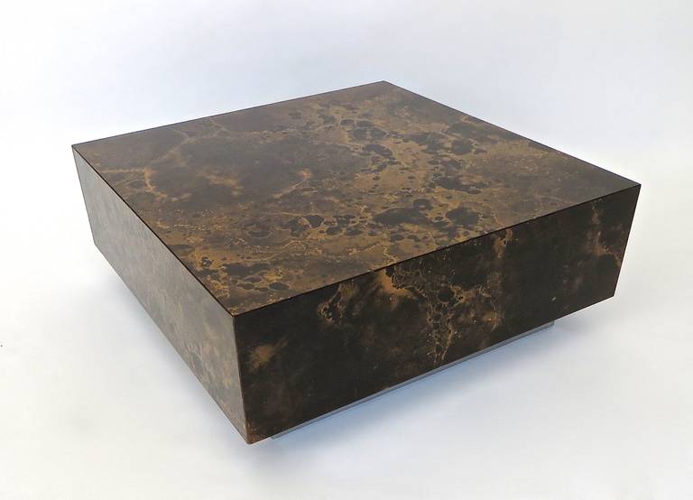 French laminate coffee table by Guy Lefevre for Ligne Roset, circa 1960.
Brown, black and copper swirling celestial patterned laminate floating on steel base. 
A few minor scratches hardly detachable because of the heavy patterning of the swirling