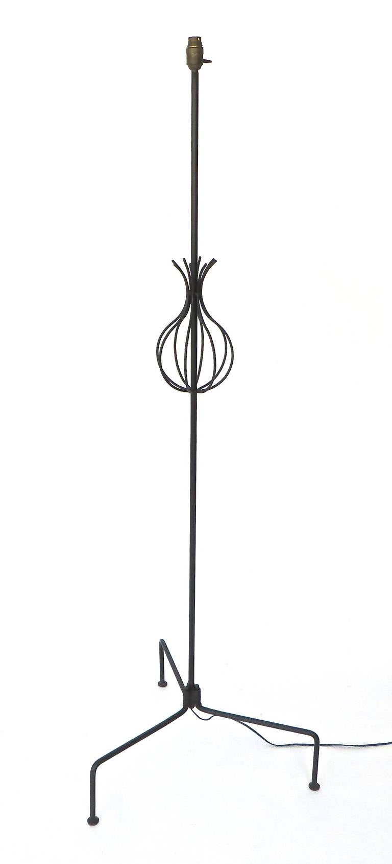 Interesting French floor lamp in black wrought iron with a pineapple or basket motif in the central portion on splayed legs. Very architectural. 
Attributed to Rene Jean Caillette, circa 1950
64