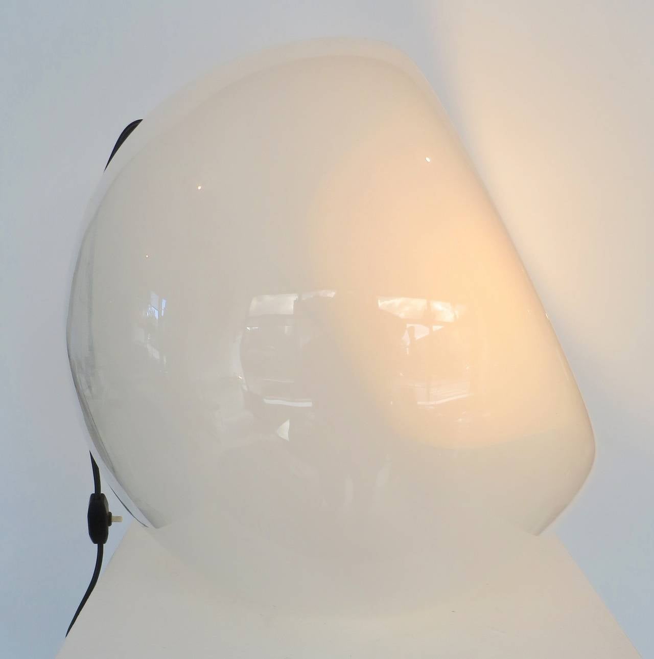 Italian mold blown Vacuna Artemide Murano encased glass opaque white table lamp that can be positioned two ways. Very unusual and unique. The light is very  hard to capture and it is very white not rosy toned but the double glass can easily be seen.