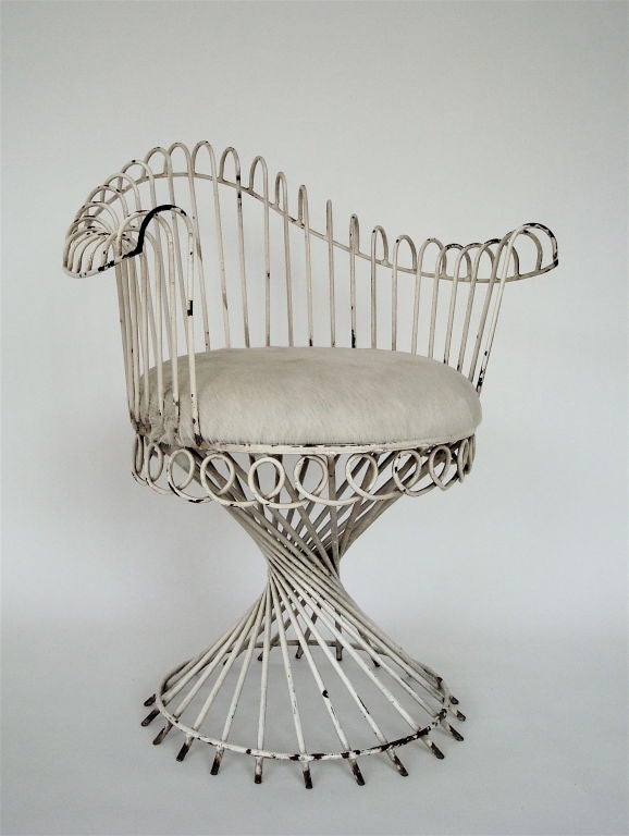 Hand wrought iron arm chair by Mathieu Mategot.  Original condition, with a hair on hide upholstered seat. Documented in 