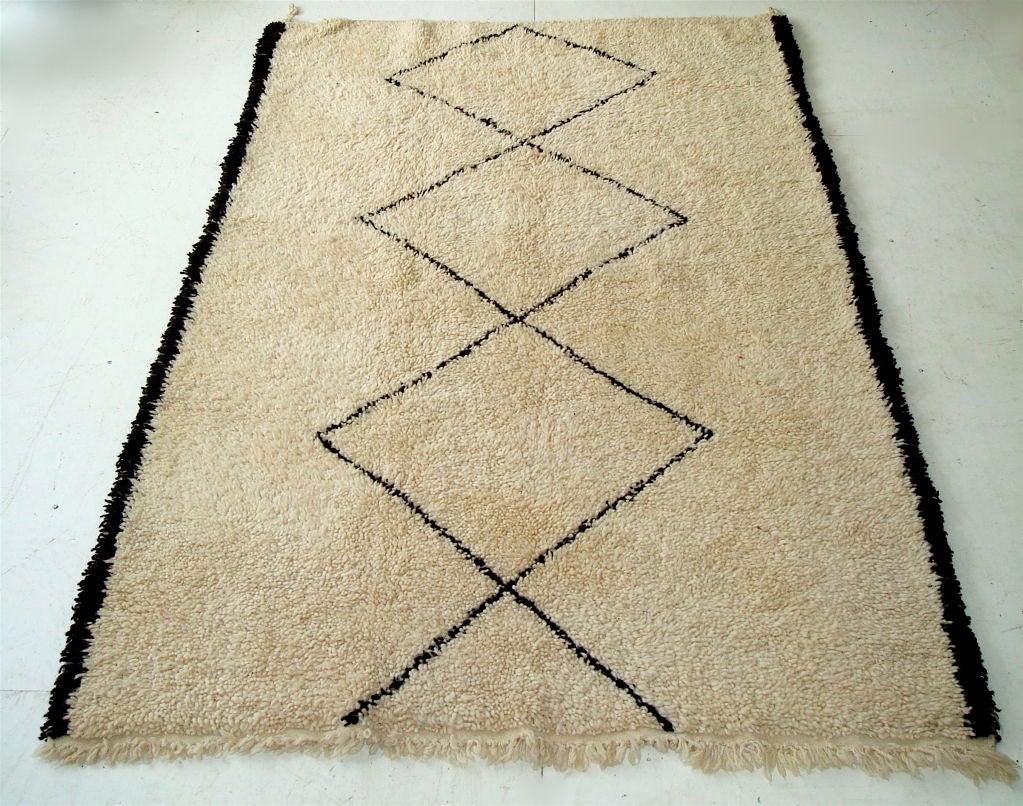 Beni Ourain Tribal Berber Atlas Mountain rug.  Later half of the 20th Century.  No two rugs are ever alike. Cream with a very dark brown pattern and edges.