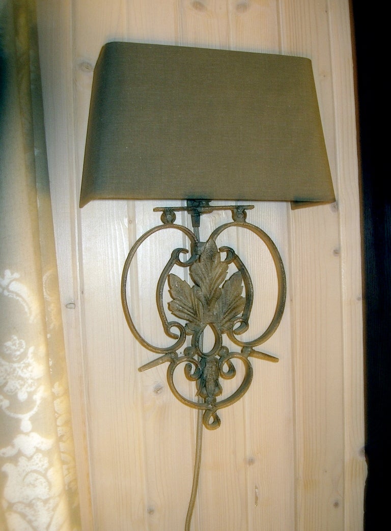 Set of four patinated iron sconces with linen shades