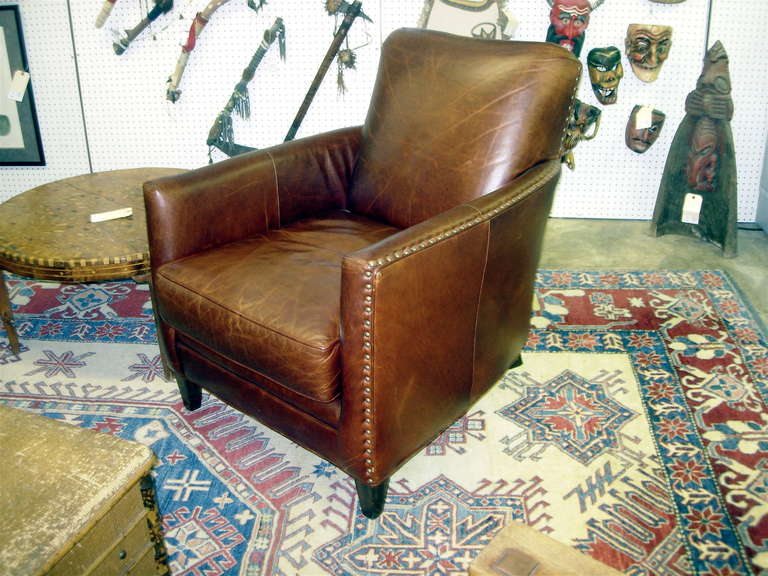 One pair of vintage deco leather chairs with nail head trim.  Lovely old patina but in very good condition.  We also have other styles of leather chairs and sofa's with distressed leather.