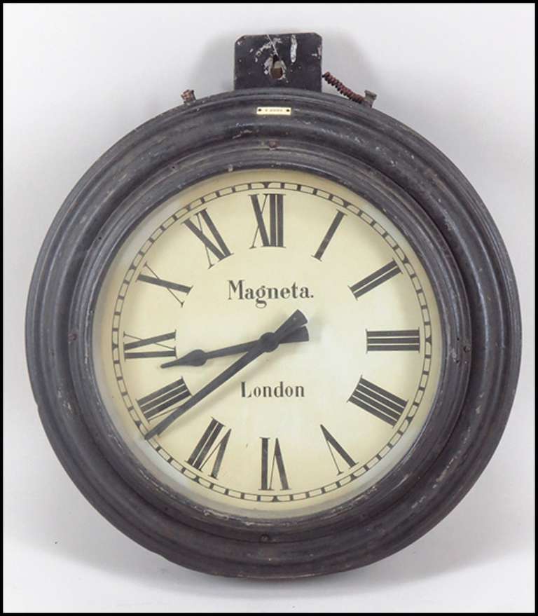 Double sided English tole station clock with lovely old worn patina.  Marked 'Magneta, London' Great piece to suspend in an open area.
