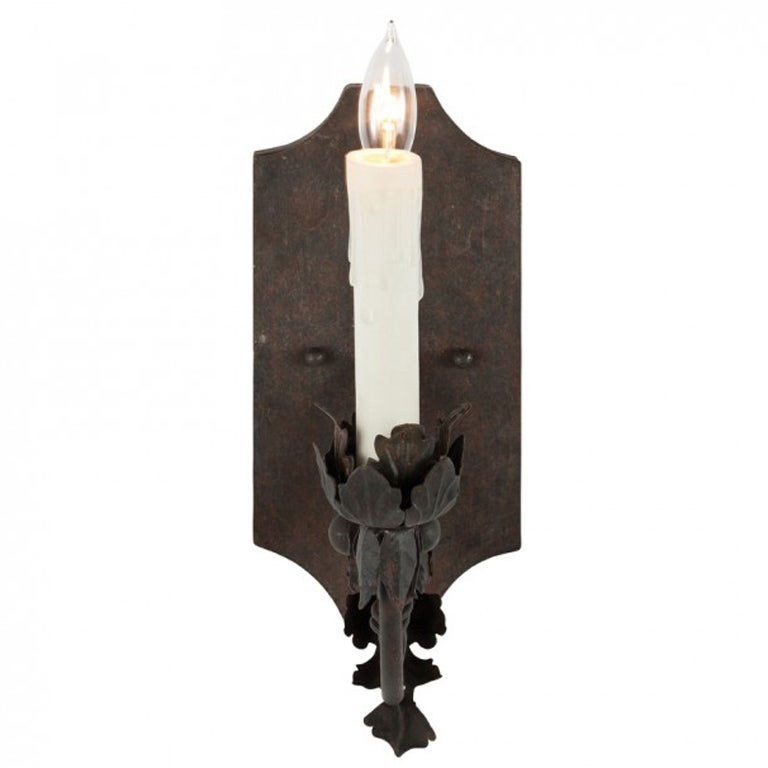 Ten French iron single arm sconces lovely patina, we also have the complementary three-arm sconces. Note priced per sconce.
