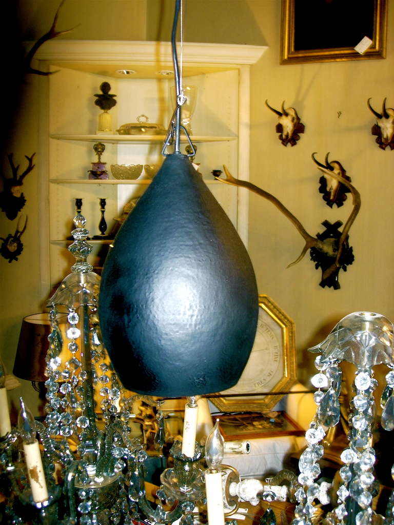 Three matte black hammered pendant light fixtures with gold finish interior. Great fixture for over a kitchen island.