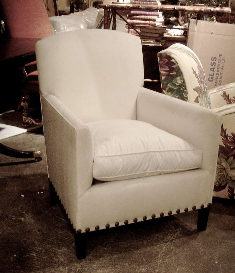 One pair of English Art Deco style club chairs with nailhead detail. Great compact scale, yet very comfortable. Very sexy lines. Down wrap cushion, and can be upholstered with customer's own material at no extra charge.