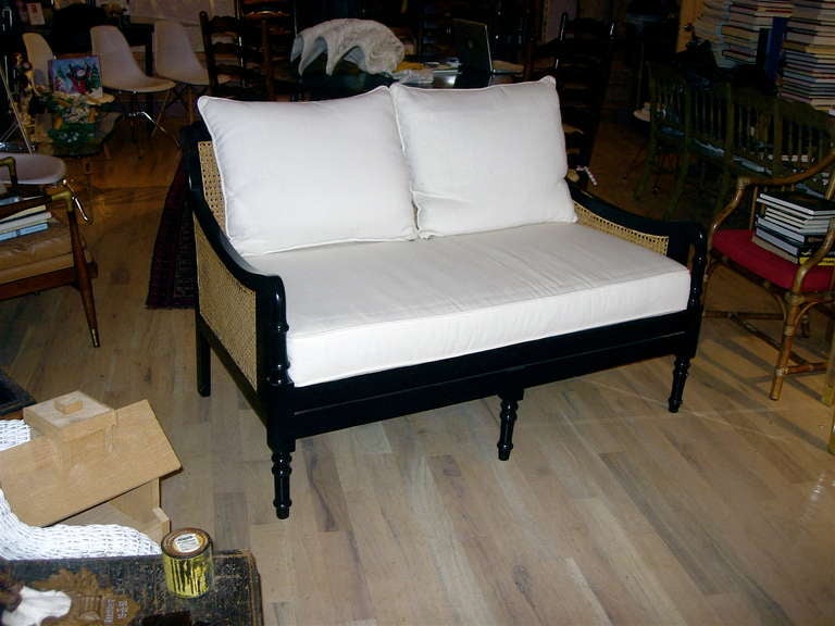 One Pair of British Colonial Style Two-Seat Settees Covered In White Cotton Canvas. We also have a sofa that came out of this suite.