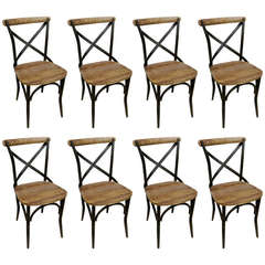 Handsome set of eight iron and wood rustic side chairs.  Very industrial feel.