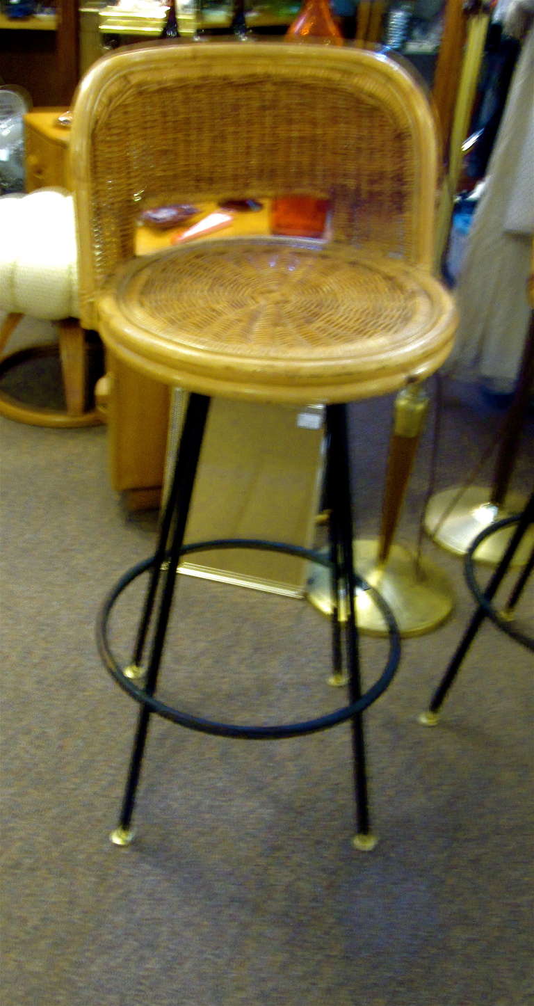 Set of five rattan and iron midcentury bar stools.