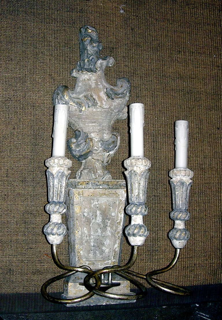 Handsome pair of Italian style carved wood three-arm sconces with lovely distressed finish. Six available. Impressive scale.  Feel free to call with further questions.  Newly wired and ready for installation.