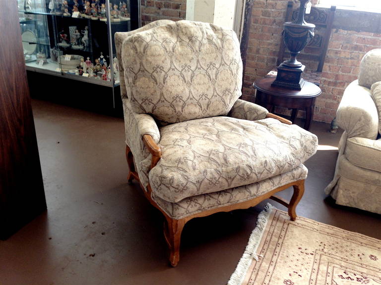 One pair of Louis XV style upholstered fauteuils with ottoman.