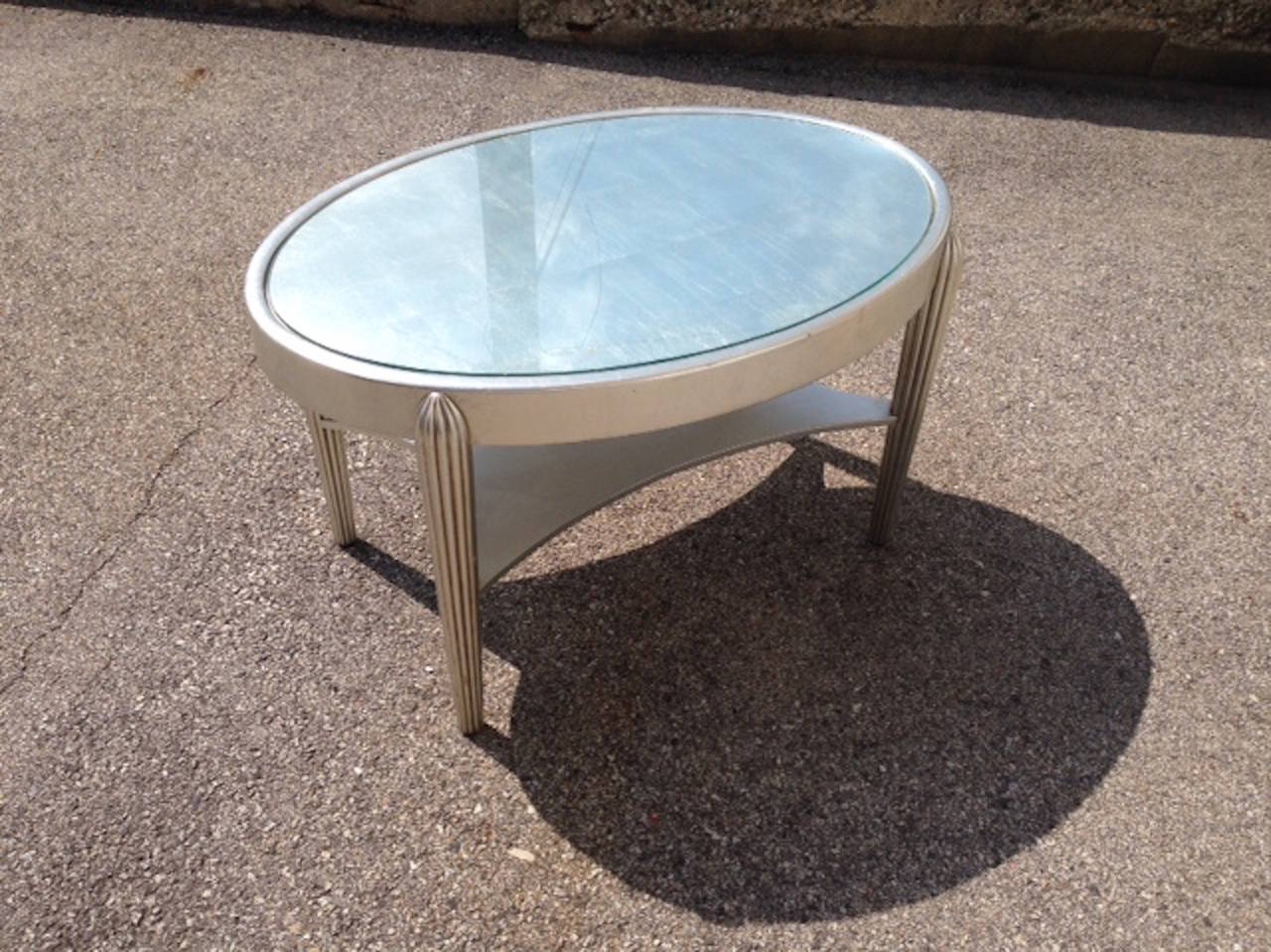 Two Art Deco Style silver leaf side tables. Inset glass top. Note priced per table.  Feel free to call with questions.