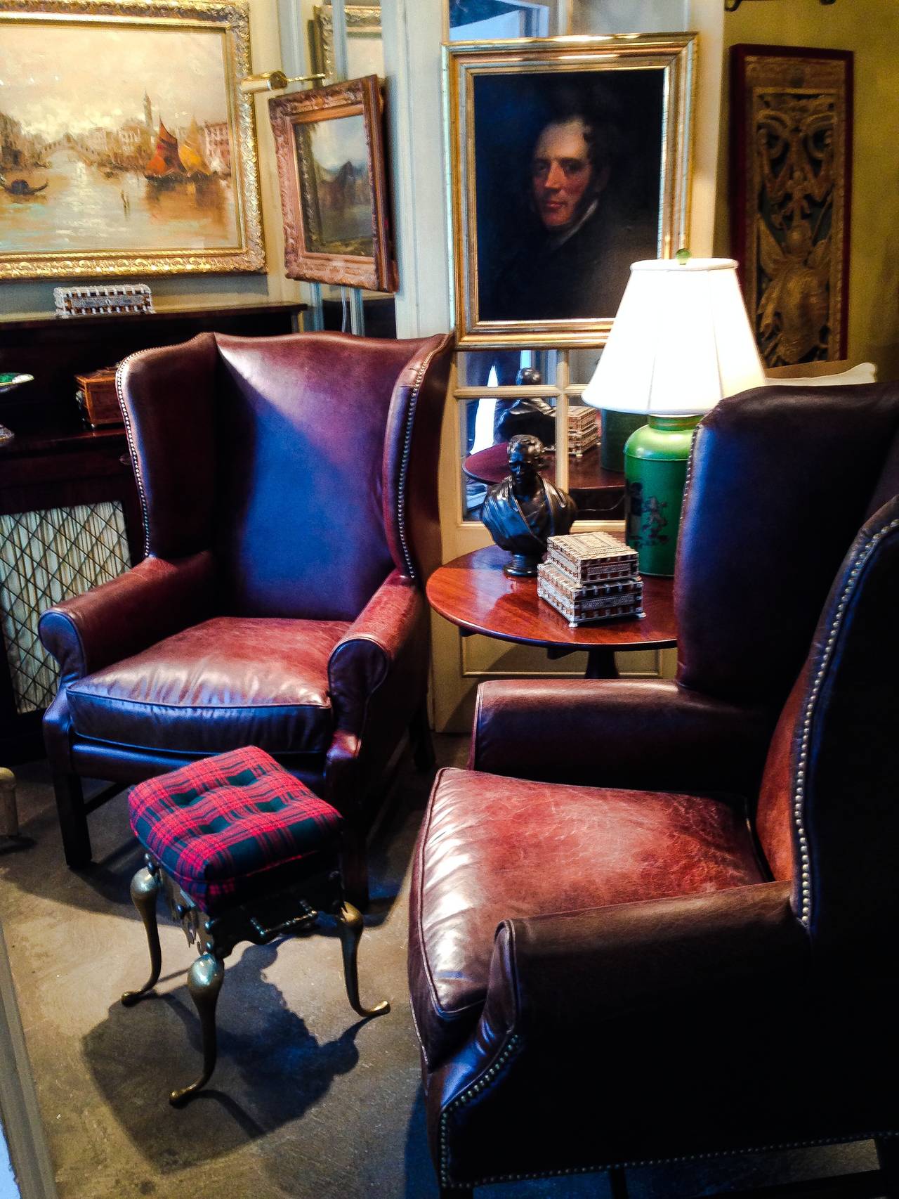 Two handsome George III style wingback chairs with nailhead and distressed leather. Nice deep wingback enclosure and leather has a lovely distressed finish yet in pristine condition. Very structurally sound. Note priced per chair and have four out