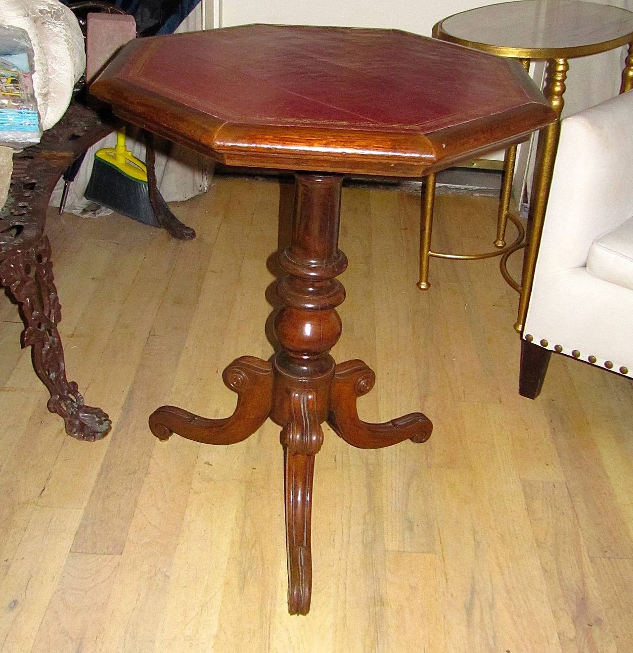 Handsome Regency leather topped side table with gilt tooling.