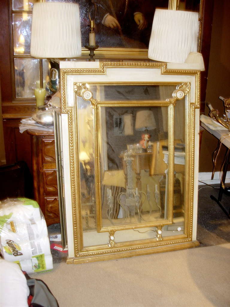 Regency style mirror with painted and giltwood decoration.