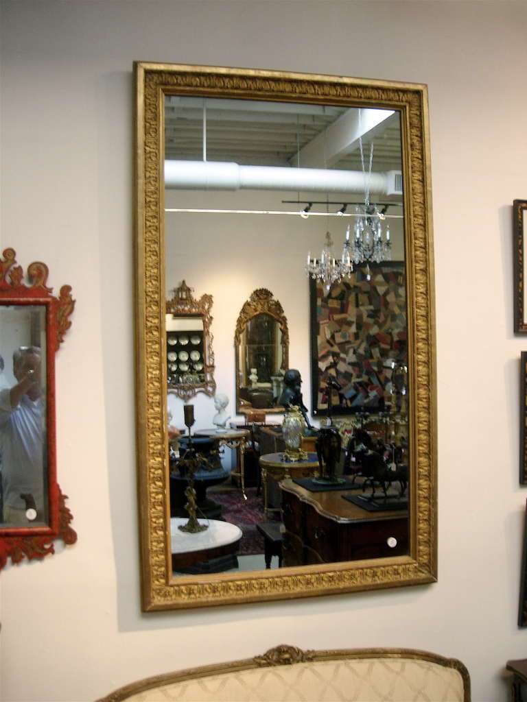 Continental giltwood mirror with original glass.