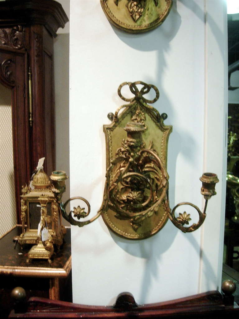 One pair of Continental giltwood three-arm sconces.