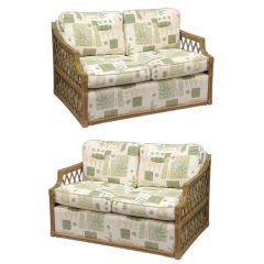 ONE PAIR RATTAN AND UPHOLSTERED SETTEES