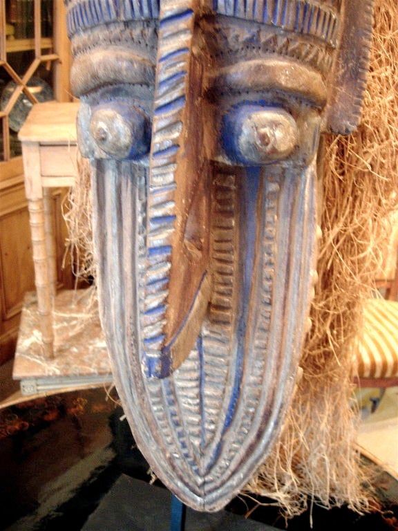 Carved wood African headdress on later iron stand.