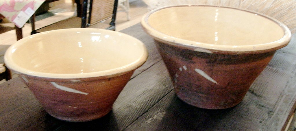 Two graduated French bread dough bowls, yellow pale glaze.