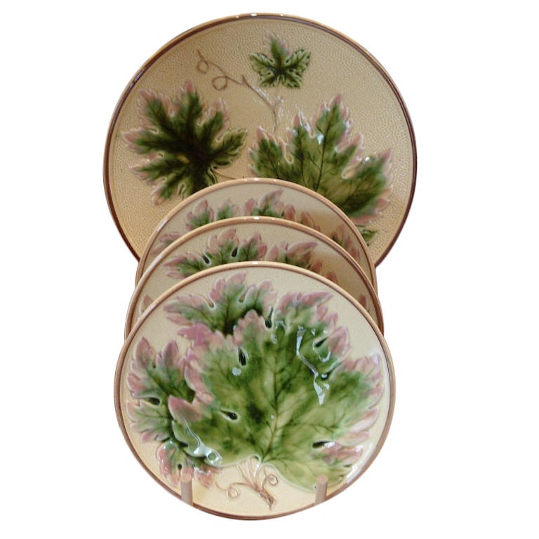 SET OF FOUR MAJECLICA PLATES WITH LEAF DECORATION.  THREE SMALER PLATES ONE SERVING PLATE