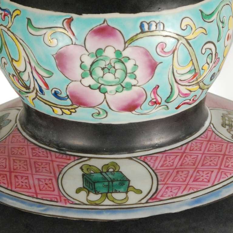 A beautiful double gourd vase from China. This early 20th c.vase is painted with brightly colored dragons and flowers.