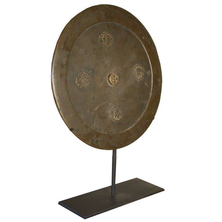 A beautiful bronze mirror c. 1900. This Chinese mirror sits atop a custom steel mount. Bronze mirrors were used in China before glass mirrors were introduced from the west.

Pagoda Red Collection # P036