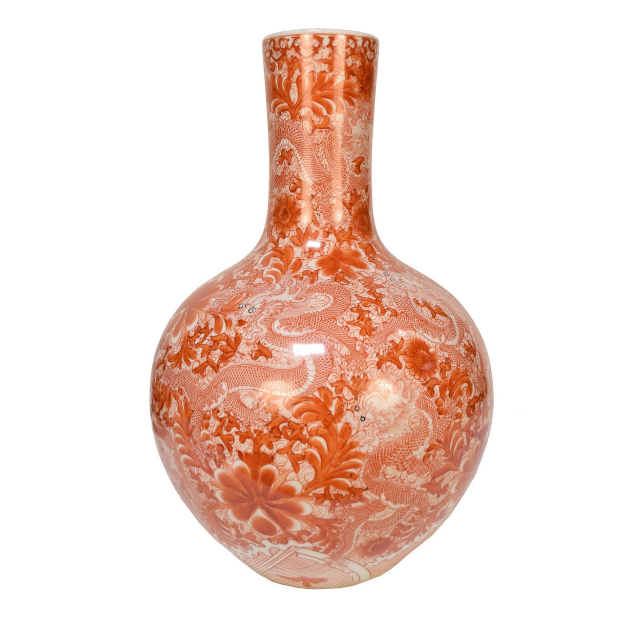A pair of gooseneck form jars depicting dragons swirling amongst vines from Beijing, China. This beautiful orange color is gained by firing the jars with copper.

                