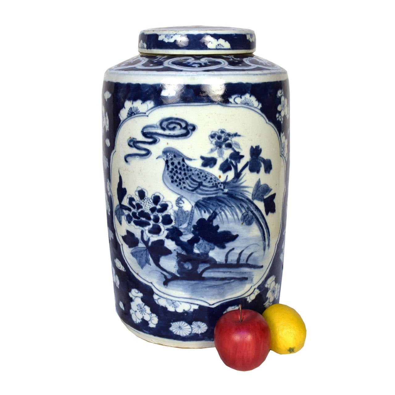 Blue and White porcelain jar with lid depicting birds, peonies & chrysanthemums, Chinese symbols of harmony, compassion, and good fortune.