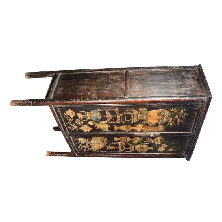 A 19th century Chinese two door cabinet with folk painted doors depicting scholars' tools and vases with auspicious flowers.  <br />
<br />
Pagoda Red Collection #:  Y066<br />
<br />
<br />
Keywords:  Cabinet, armoire, cupboard, closet, media,