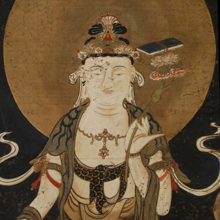 Japanese Buddhist scroll painting of goddess Guanyin holding the auspicious Ruyi scepter symbolizing power and good fortune. The Ruyi is supporting a lotus and the book of knowledge. Mounted with gilt copper.