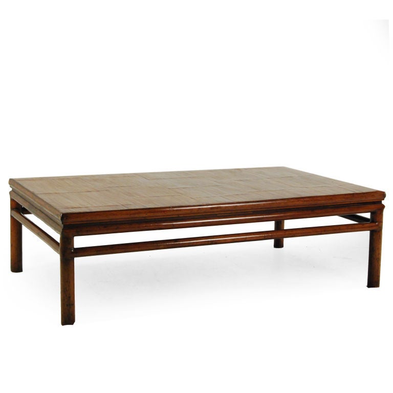 A 19th century cedar low table with crushed bamboo top, simple stretchers and round legs.
