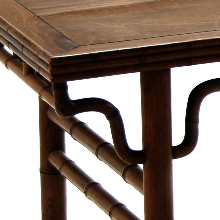 A 19th century Chinese elmwood painter's table carved to mimic bamboo.  